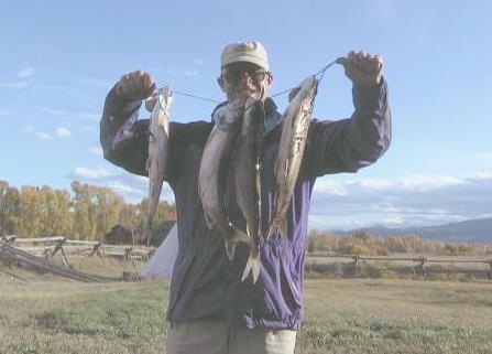 the owner with a string of lake trout.